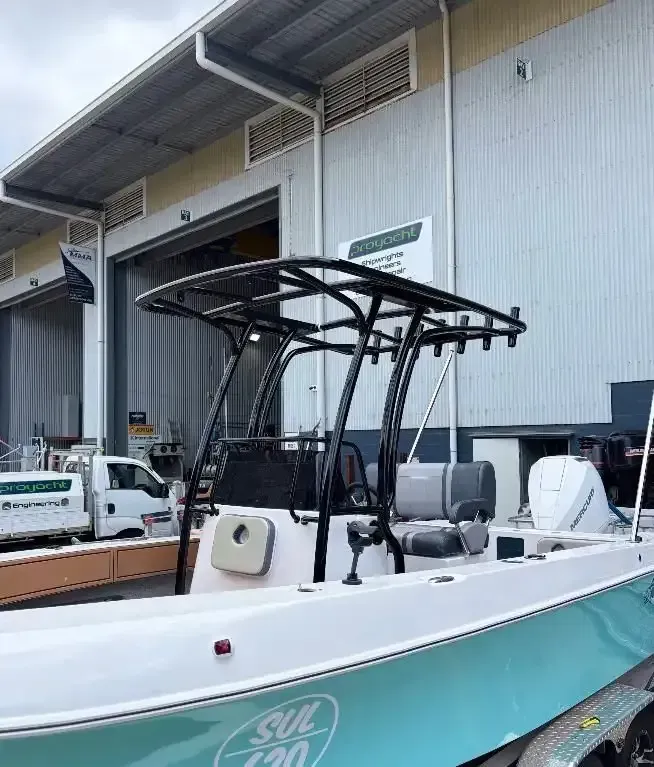 Boat With Black Canopy and Teal Accents, Parked Outside a Warehouse — Master Metals Fabrication in Labrador, QLD