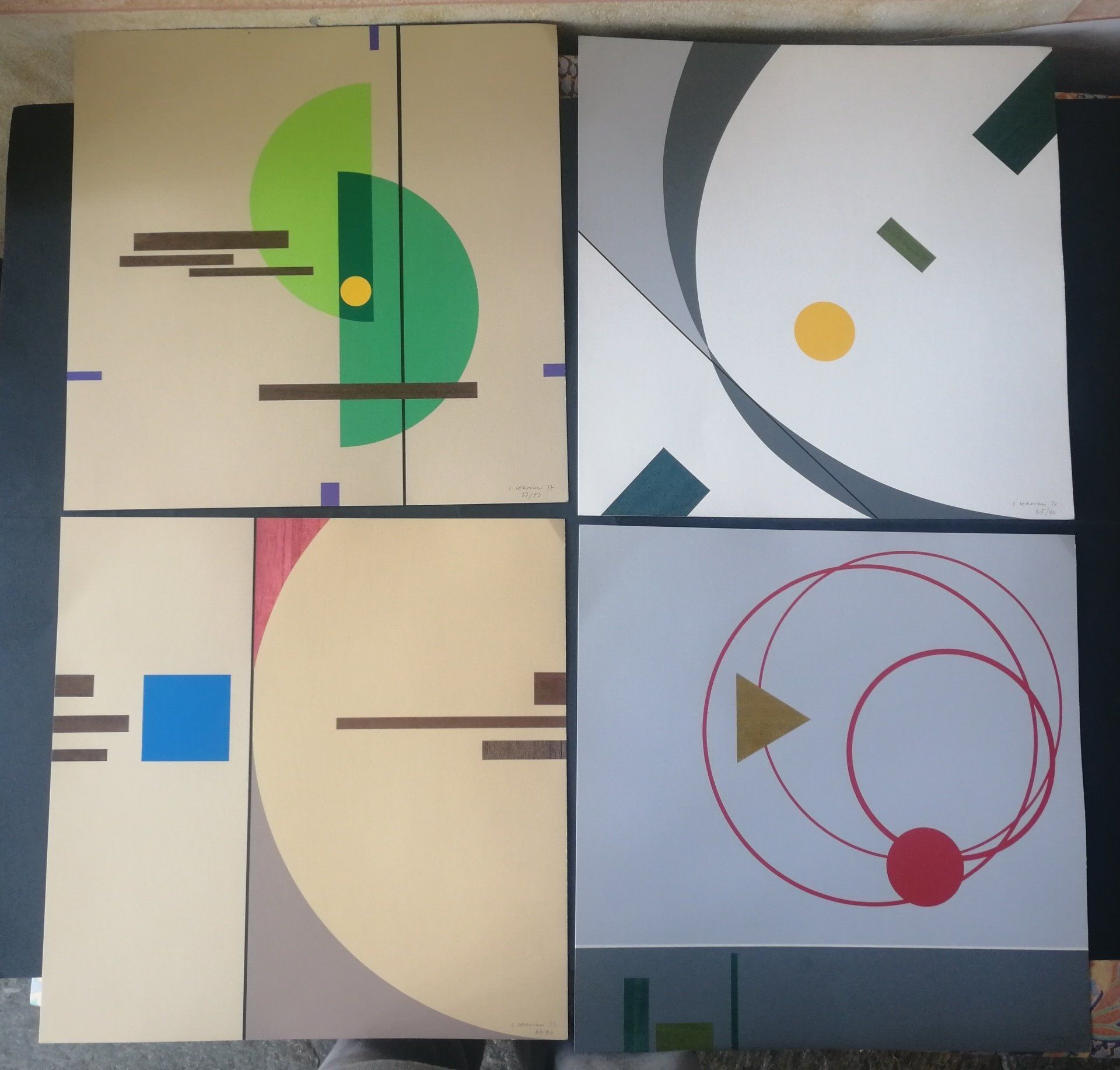 Four abstract geometric panels with circles, lines, and blocks in green, gray, beige, and blue.