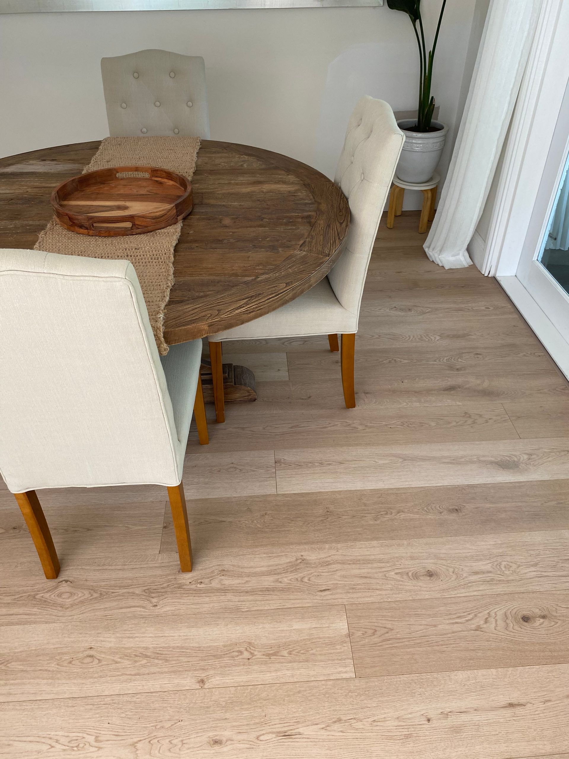 Round Wooden Dining Table With Beige Chairs and Tan Flooring — My Timber Flooring Blinds & Shutters in Erina, NSW