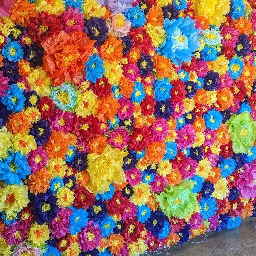 Colorful flower wall with bright paper blossoms in various colors.