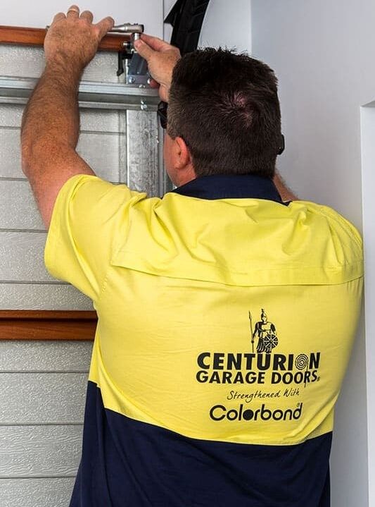 A Man Wearing a Yellow Shirt — Gem Garage Doors in Coffs Harbour, NSW