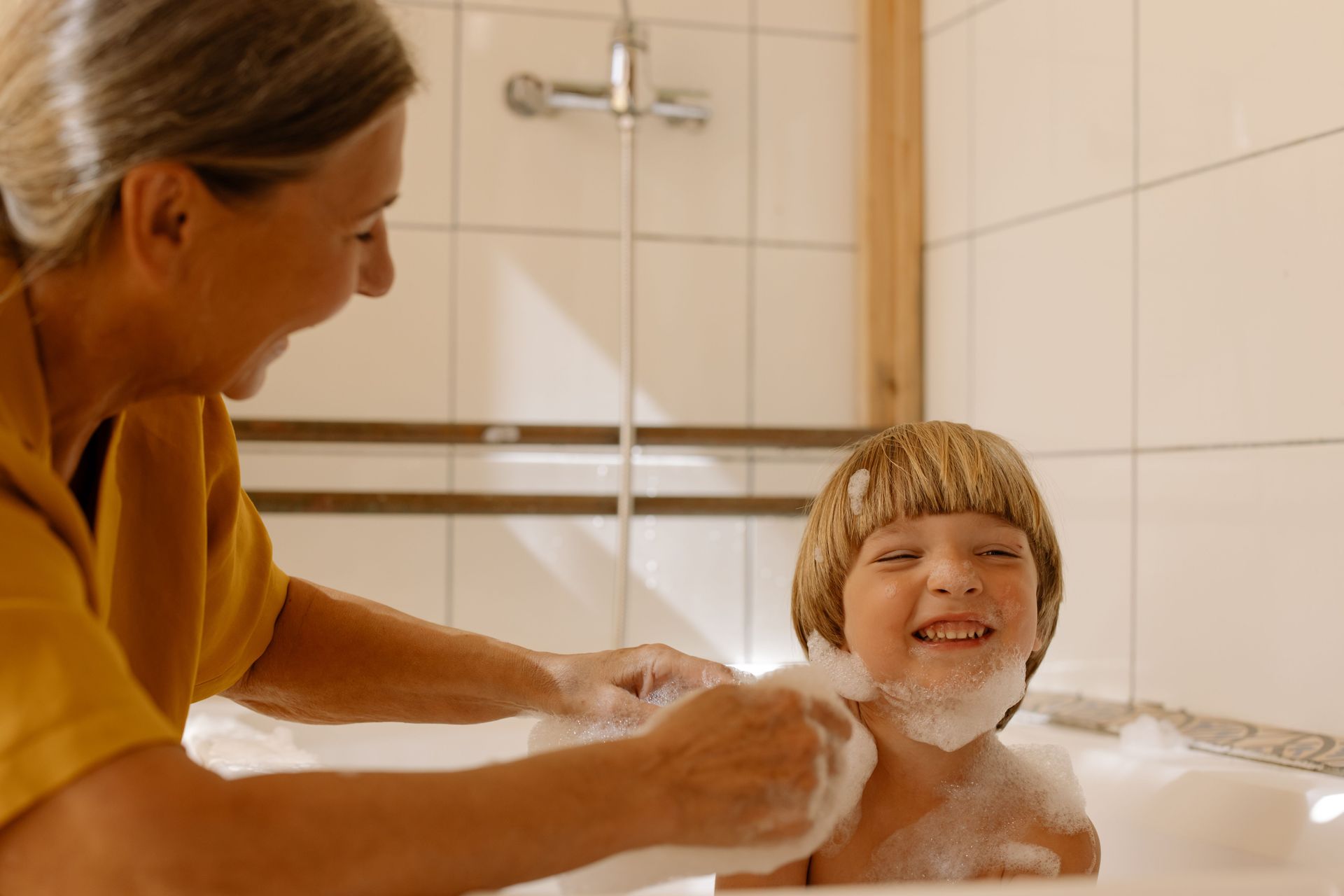 Lancaster Plumber near me for water filtration systems | hand holding a glass under a kitchen faucet