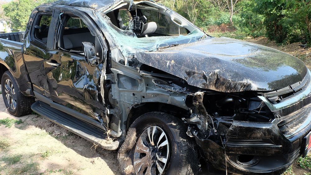 Damaged Black Pickup Truck With Crushed Front, Broken Windows, and Debris — Coastal Collision Repairs in Buderim, QLD