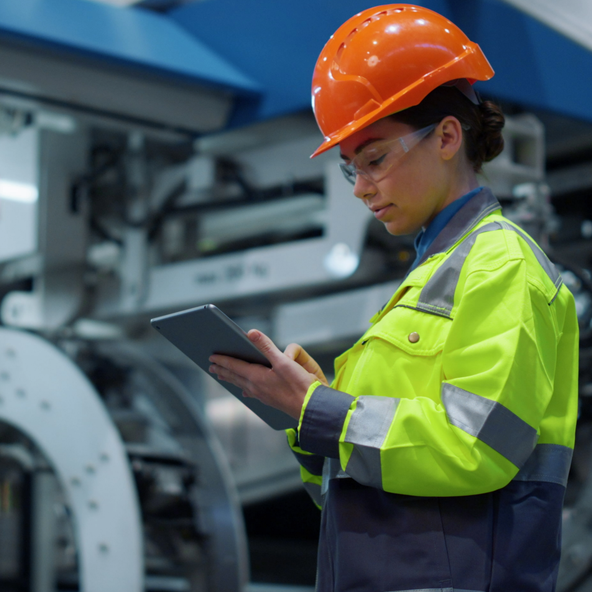 electrician at a factory writing on clip board