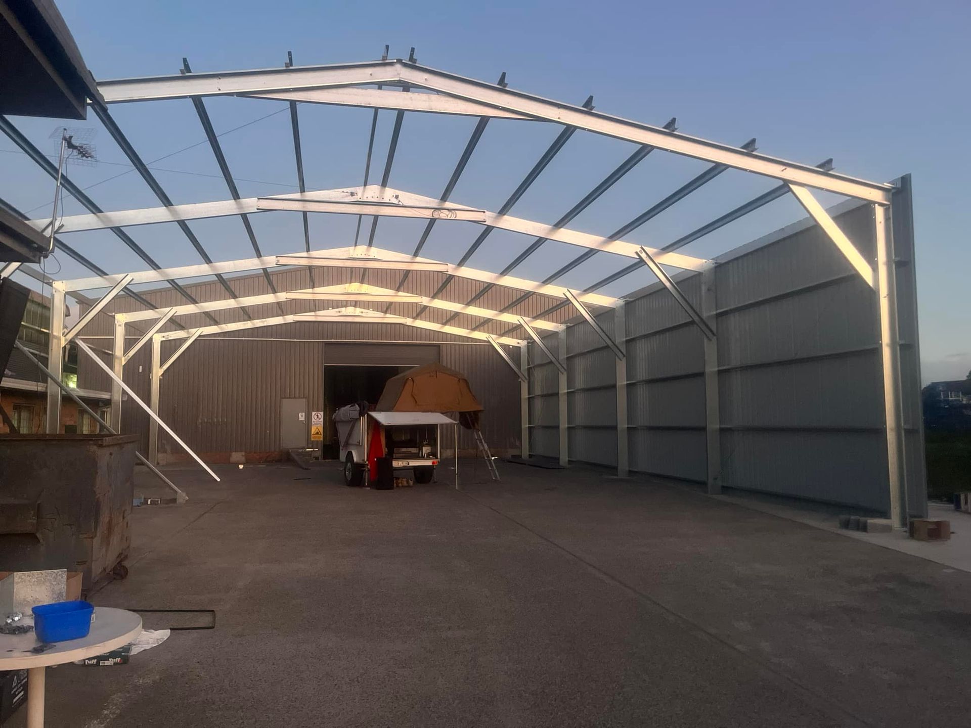 A Truck is Parked Under a Metal Structure in a Parking Lot — Mbah Metal Roofing in South Ballina, NSW