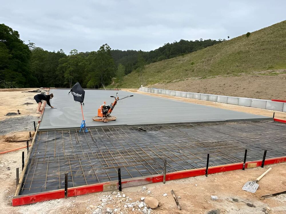 A Group Of People Are Working On A Concrete Floor  — Mbah Metal Roofing In Murwillumbah, NSW