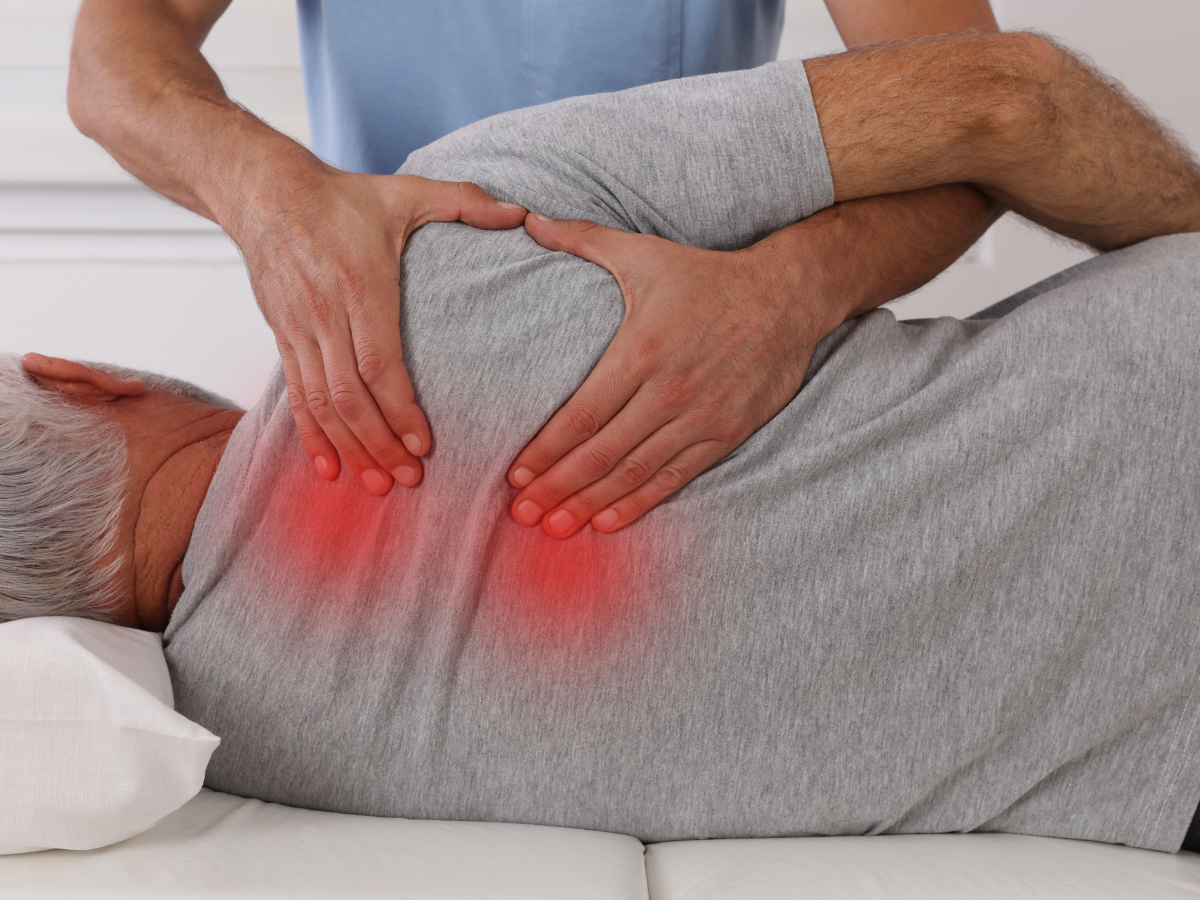 A man lying having chiropractic care