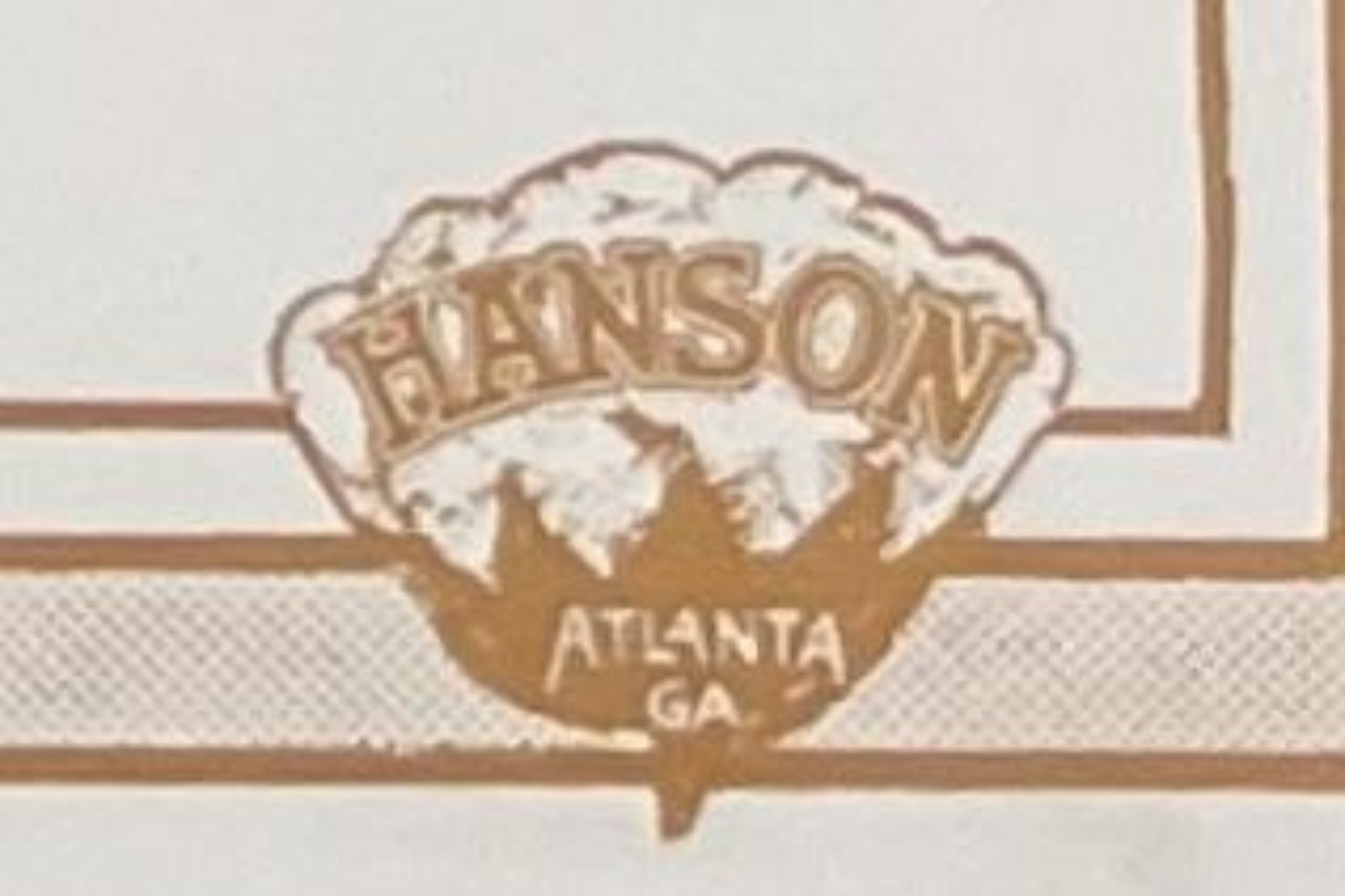 A brown, decorative emblem featuring the word