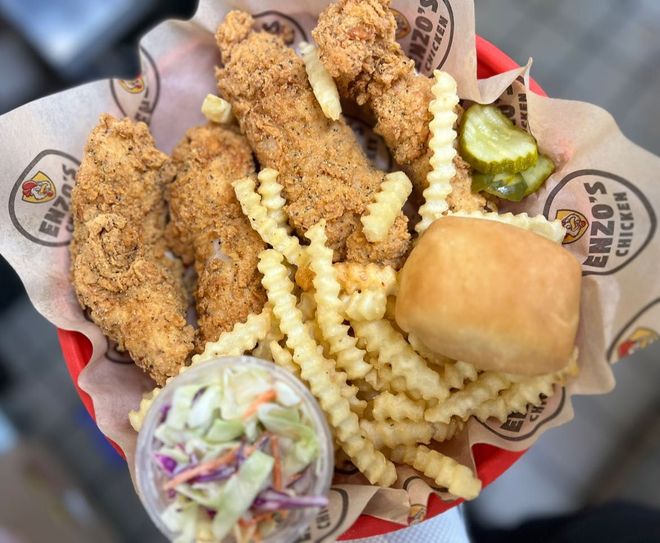 Basket of fried chicken tenders, crinkle fries, roll, coleslaw, and pickle from Enzo's Chicken.