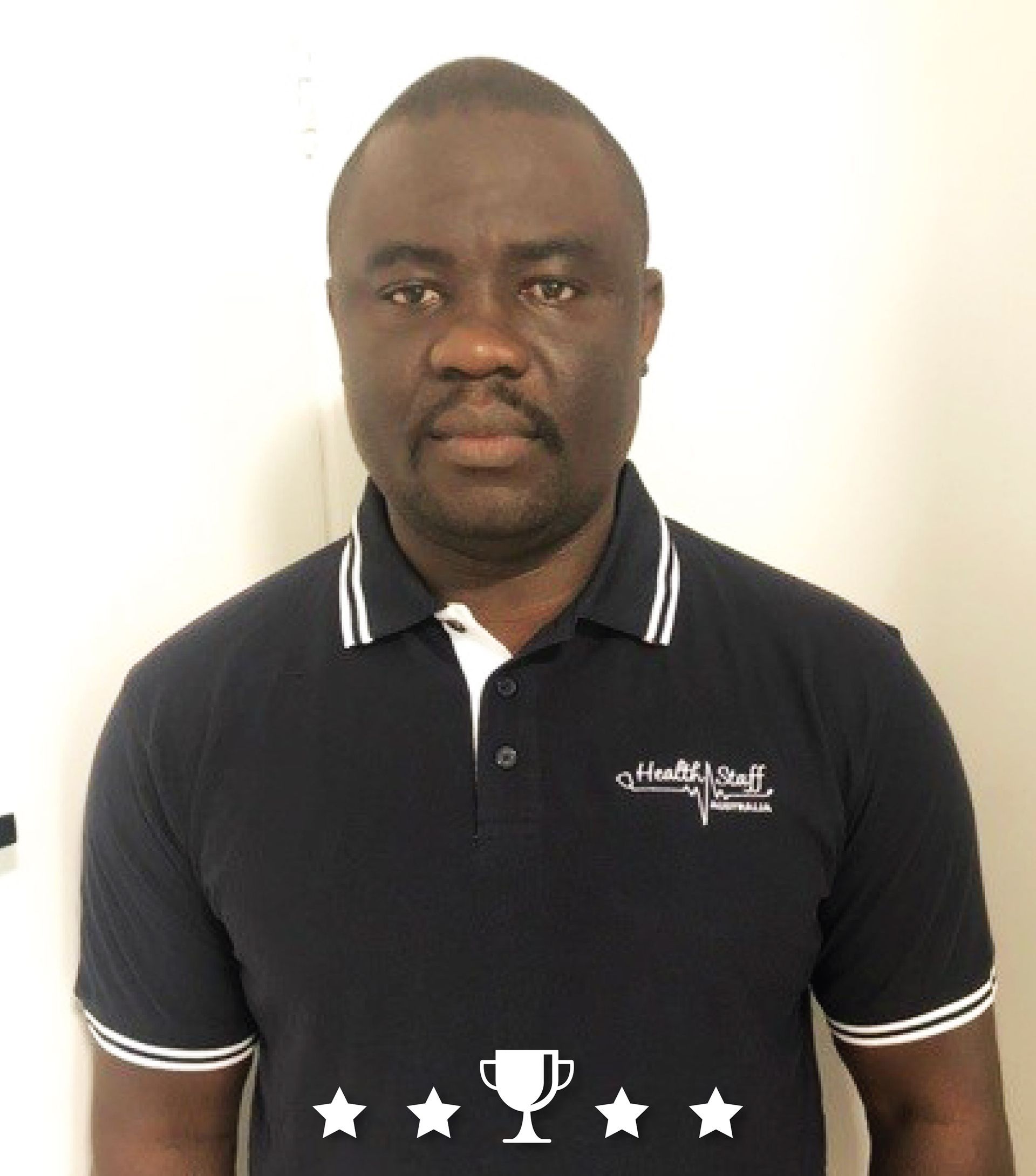 A man wearing a black shirt with a trophy on it