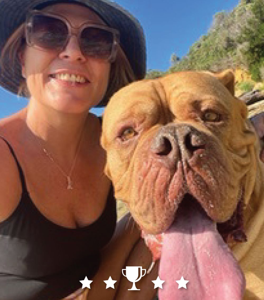 A woman is taking a selfie with her dog