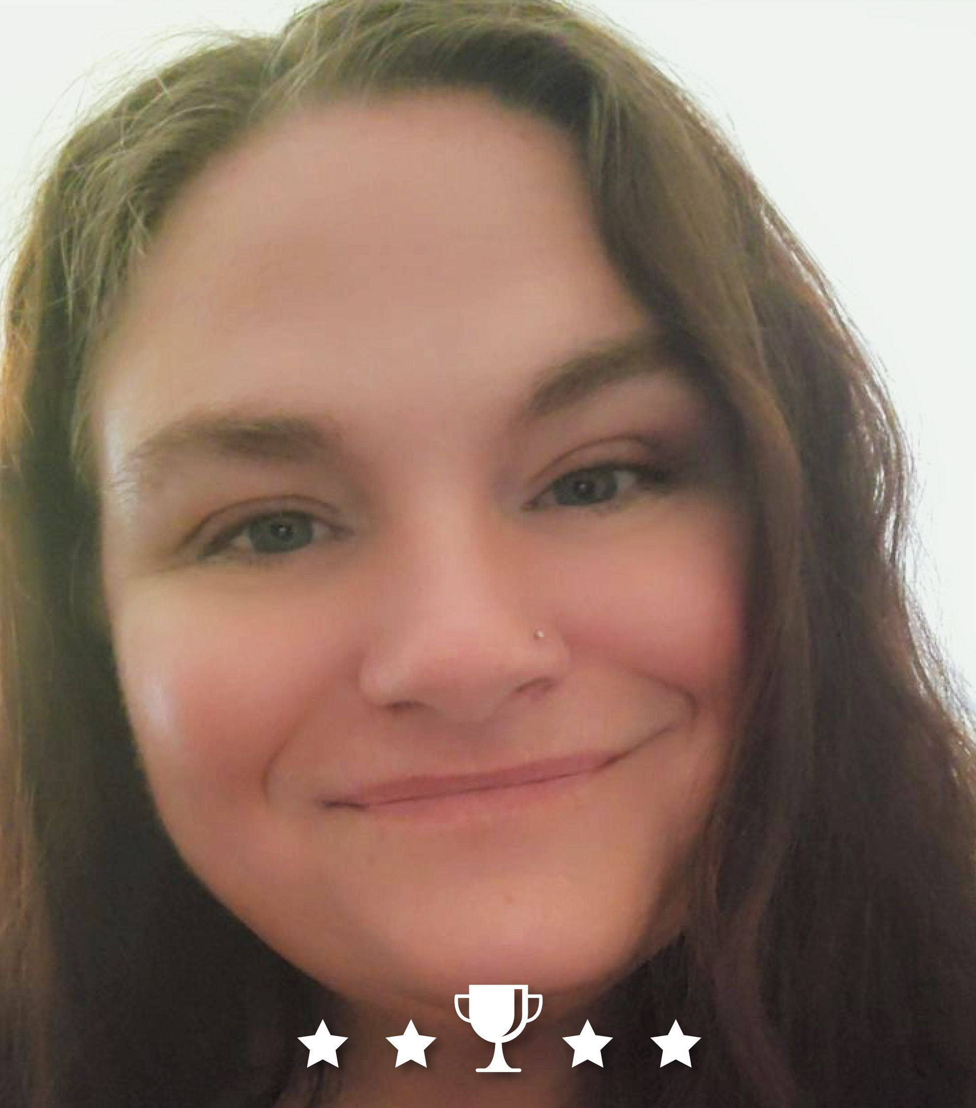 A close up of a woman 's face with a trophy in the background