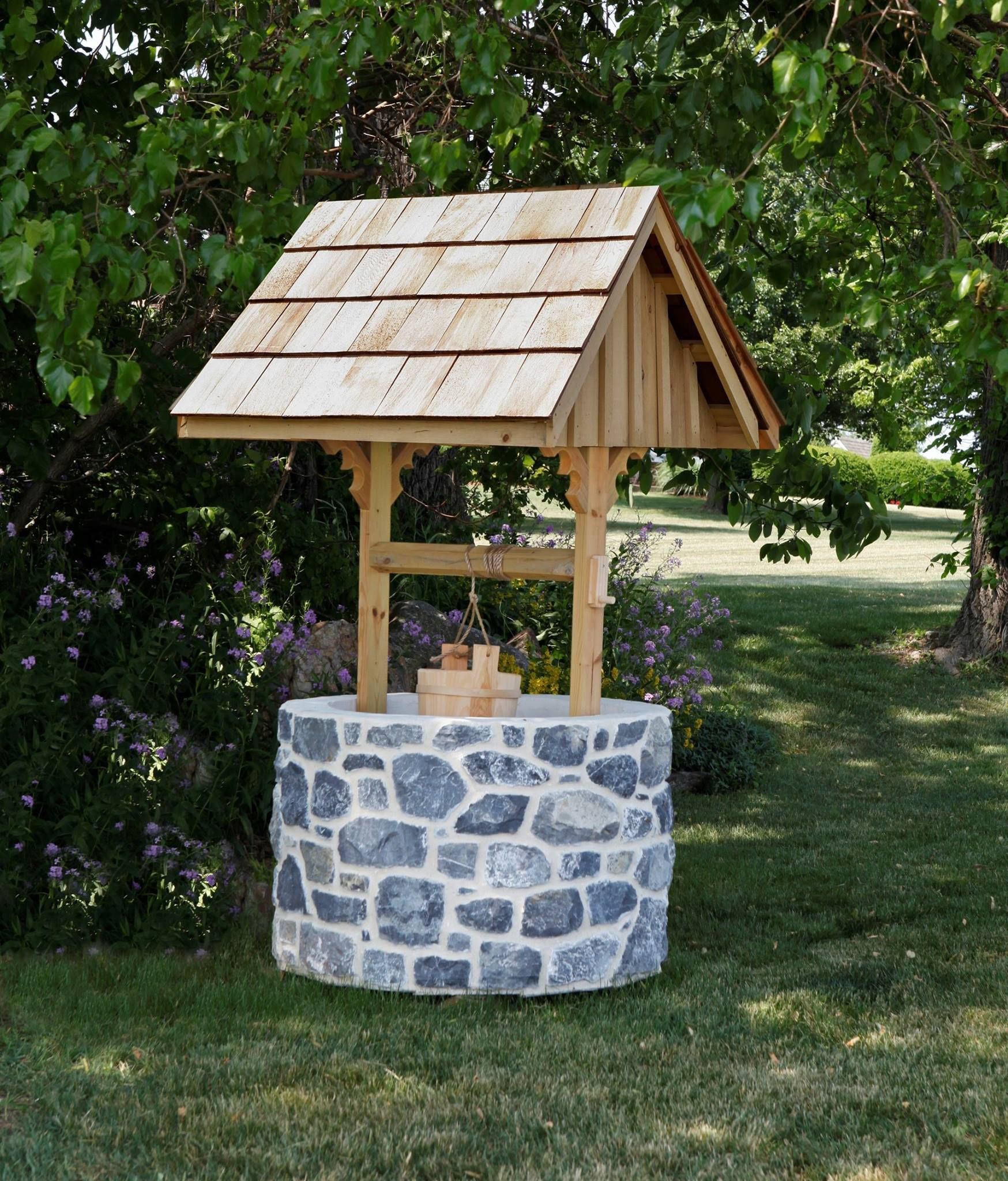 A stone wishing well with a wooden roof