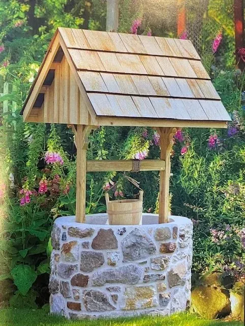 A stone wishing well with a wooden roof