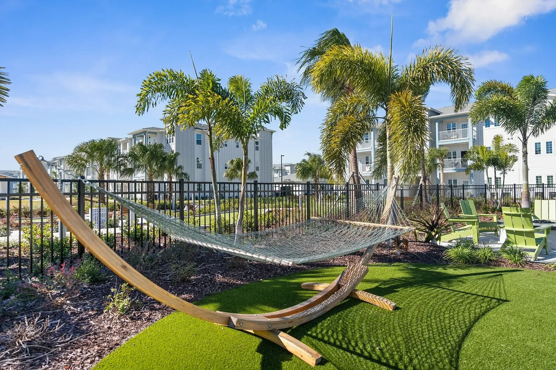 Relax in a serene outdoor escape amidst elegant apartment living.