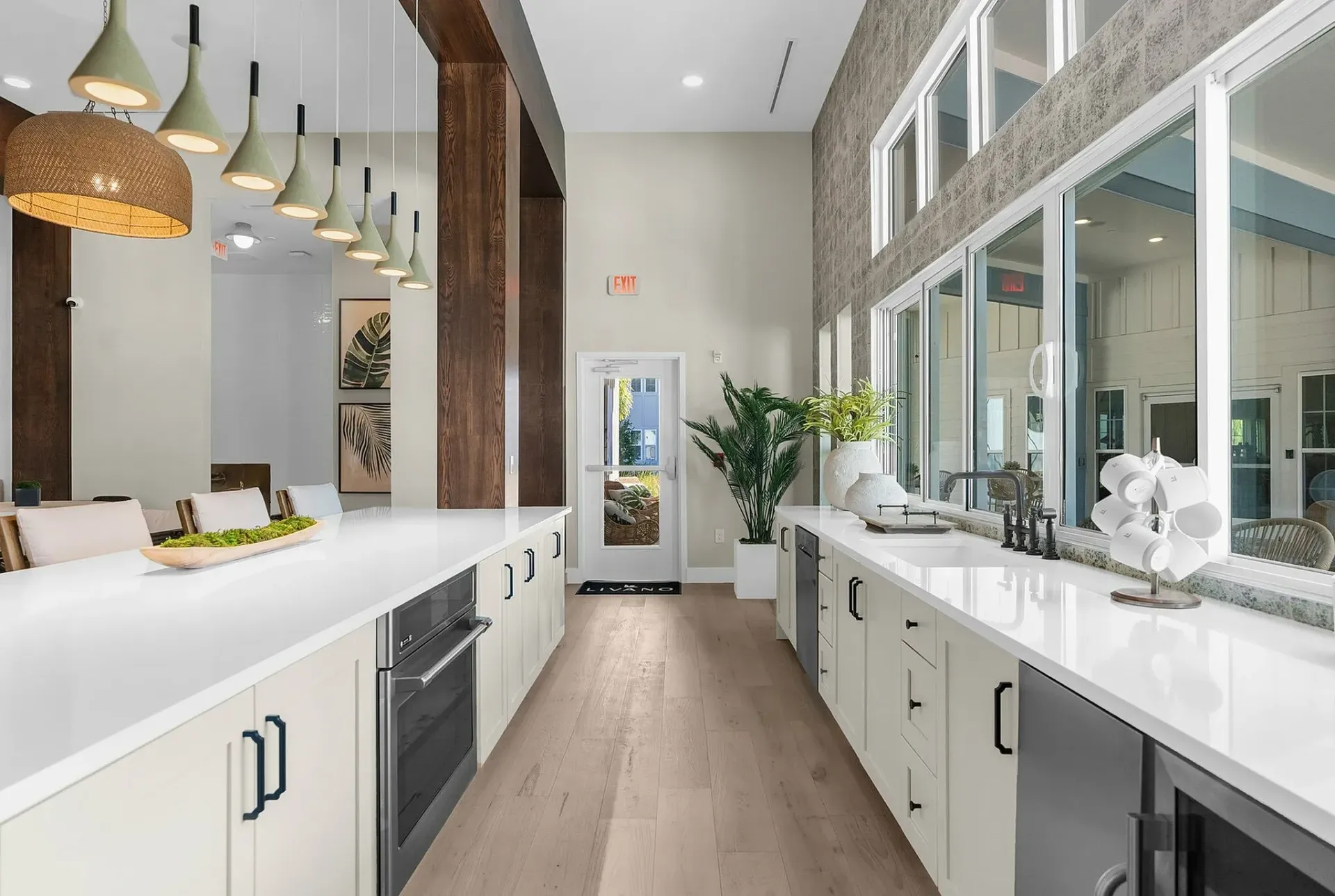 Experience modern elegance in this kitchen, featuring expansive countertops and stylish lighting.