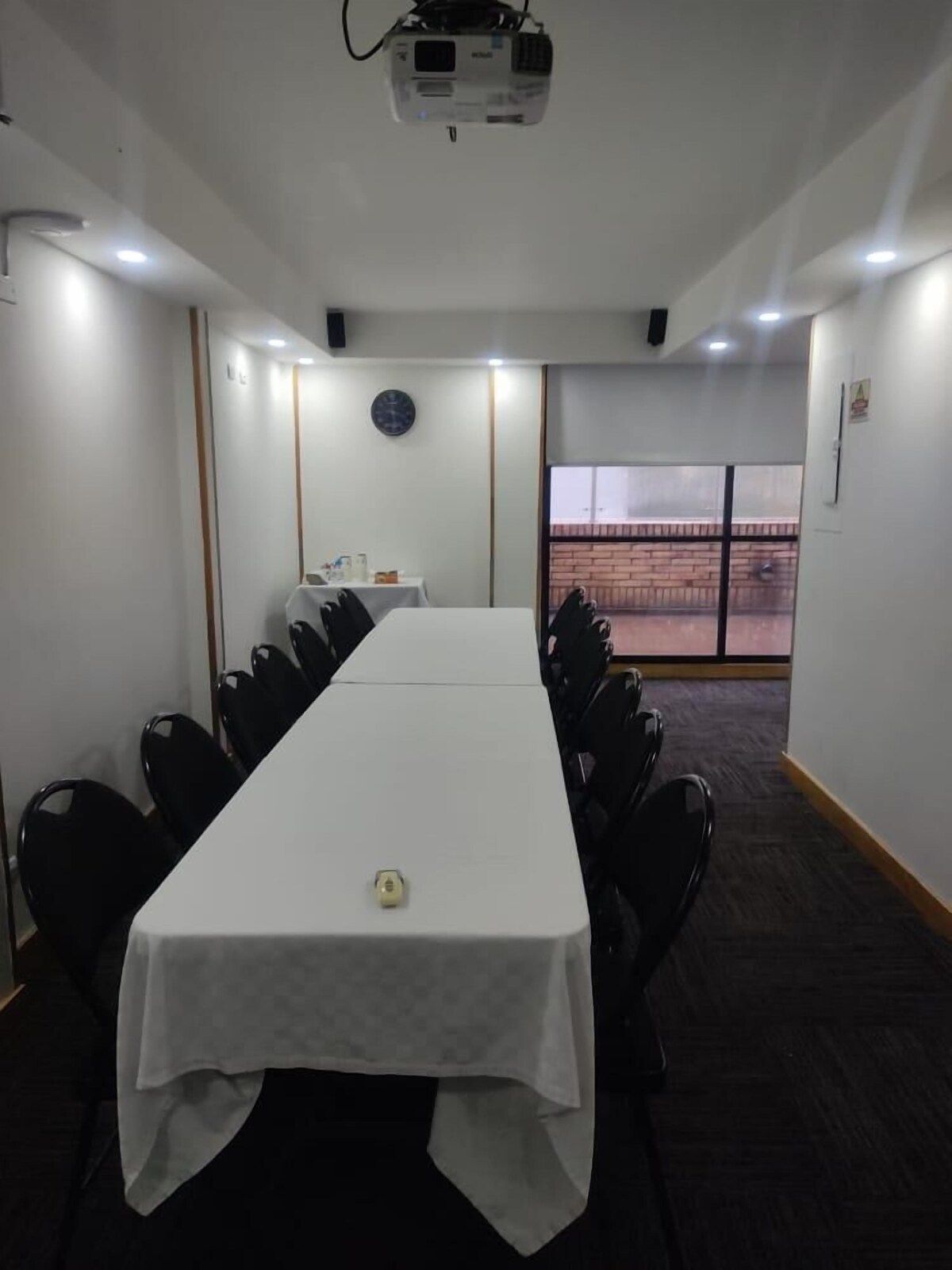 A conference room with a long table and chairs
