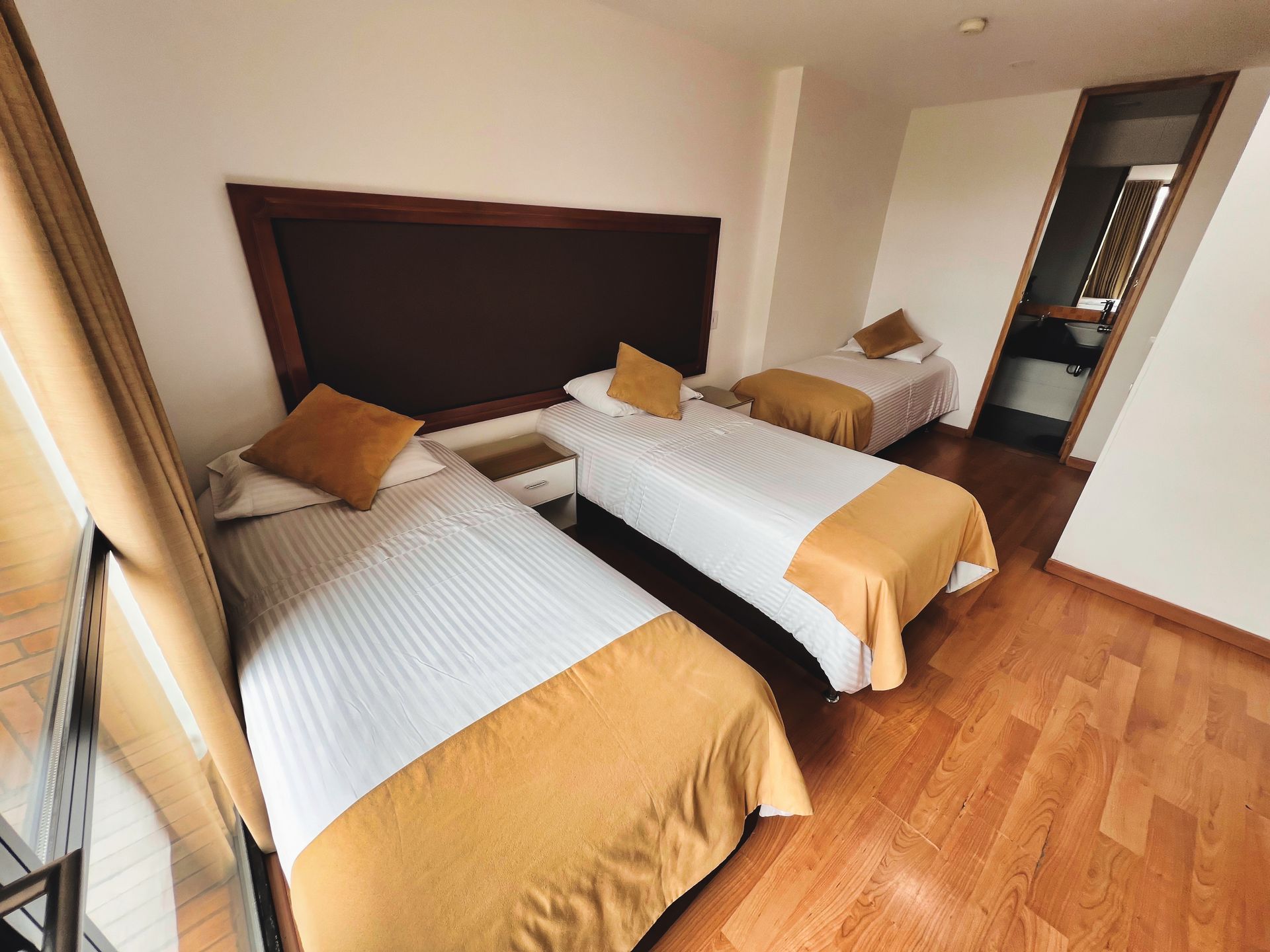 A hotel room with two beds and a blue wall