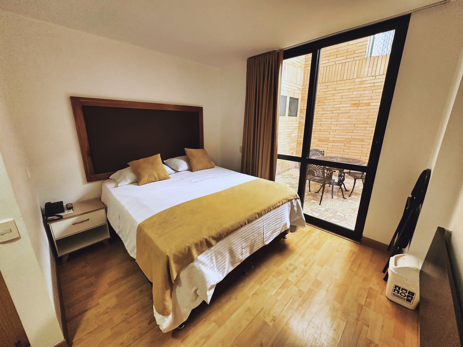 A hotel room with a large bed and a large window