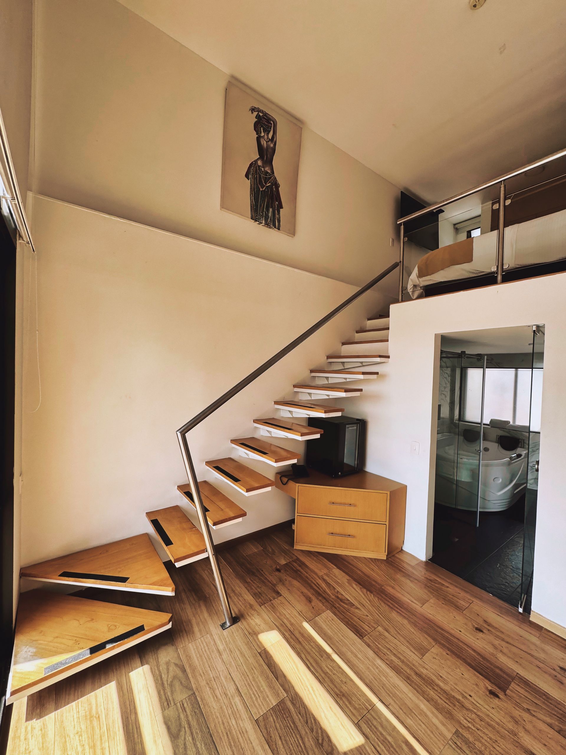 An aerial view of a living room with stairs and a couch.