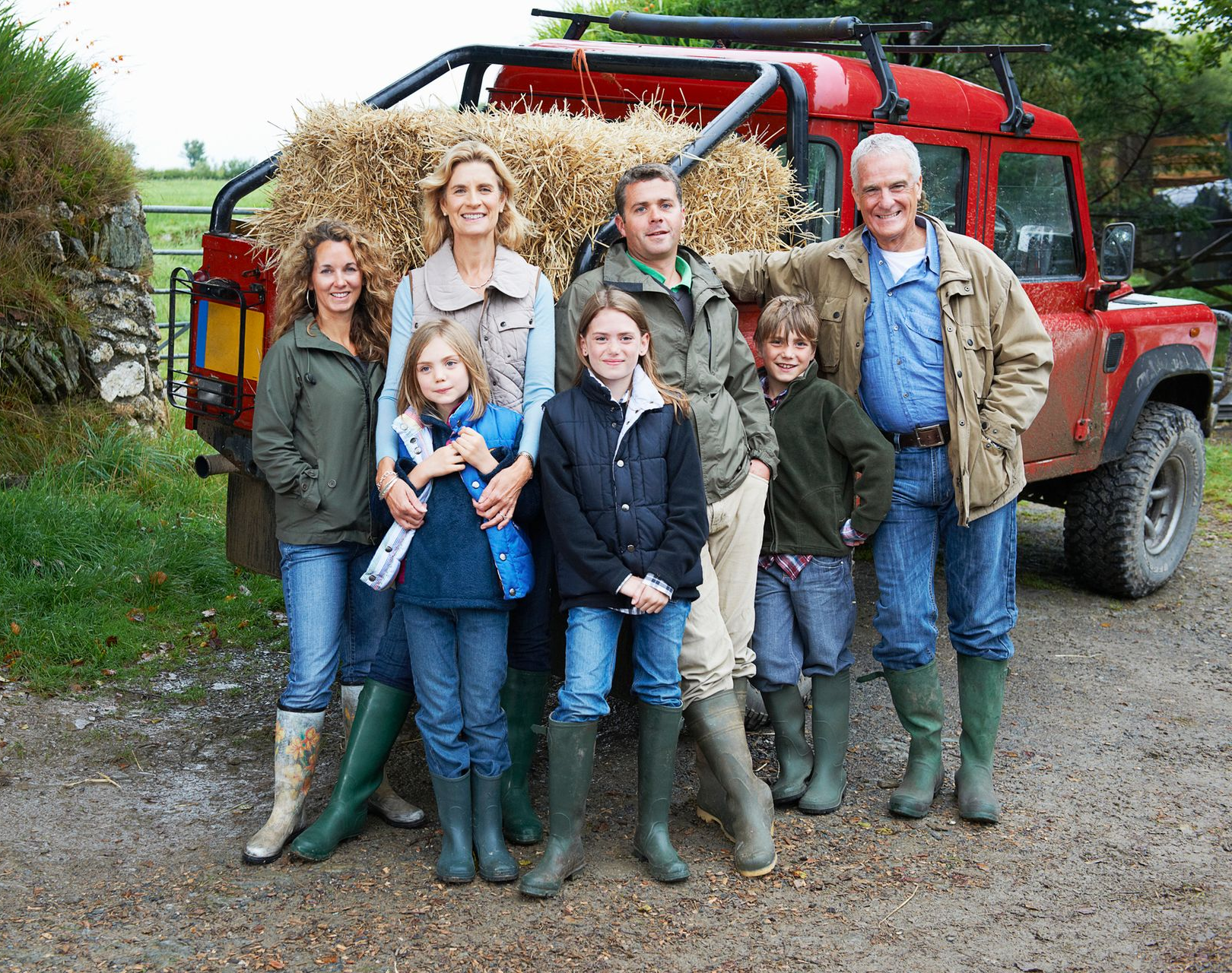 A group of people standing in front of a red truck