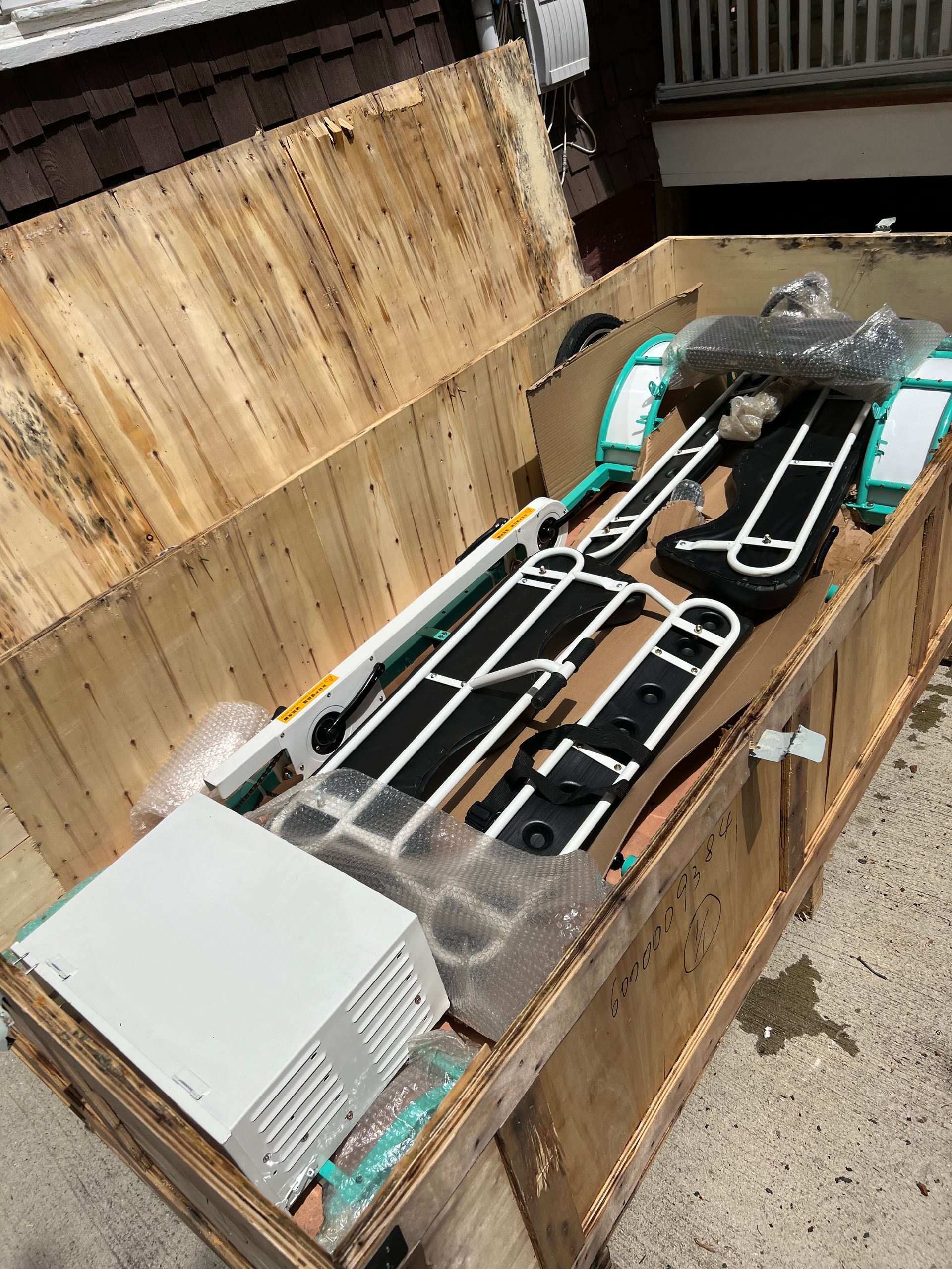 A wooden box filled with a bunch of pieces of equipment.