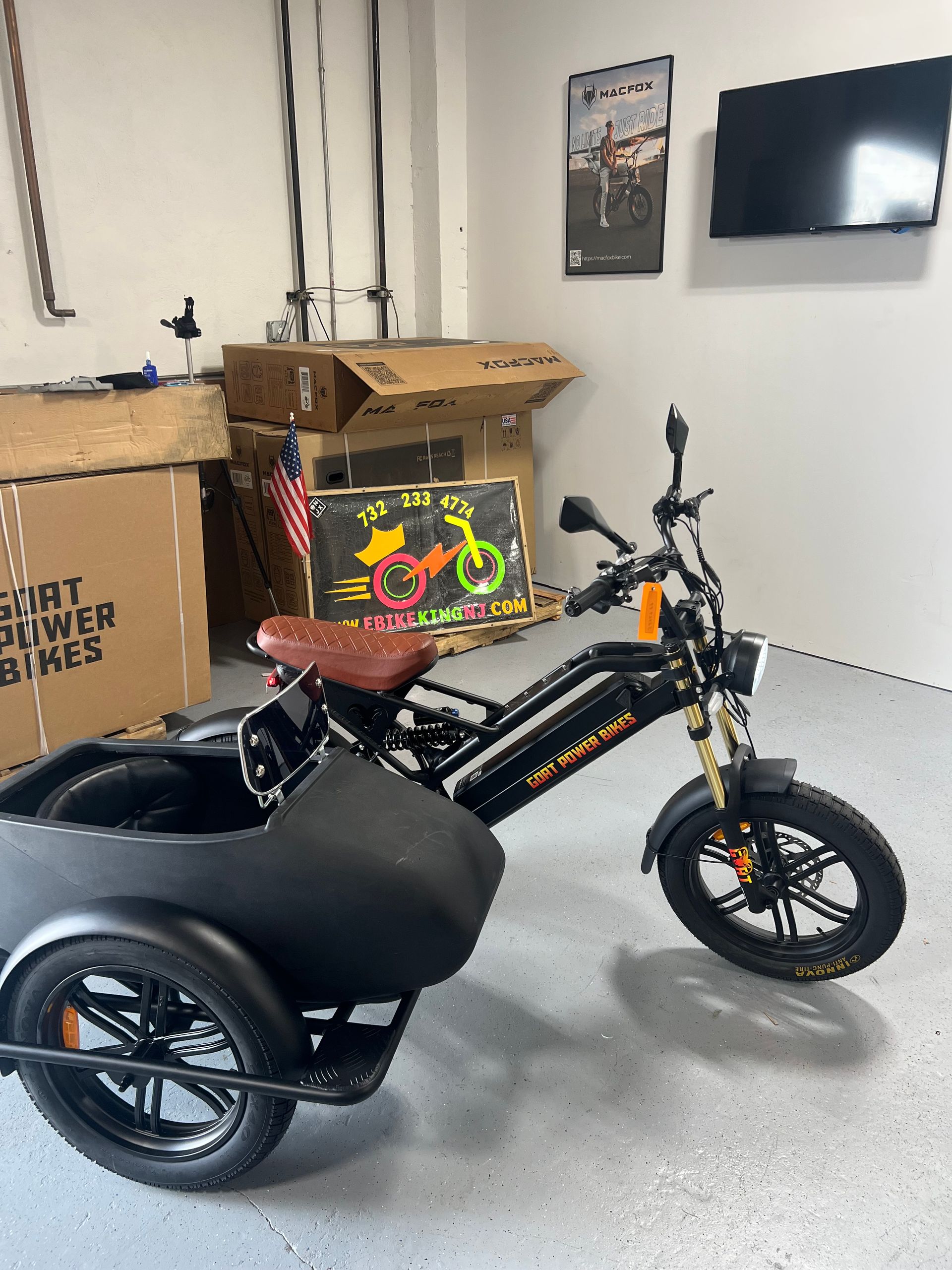 A motorcycle with a sidecar is parked in a garage.