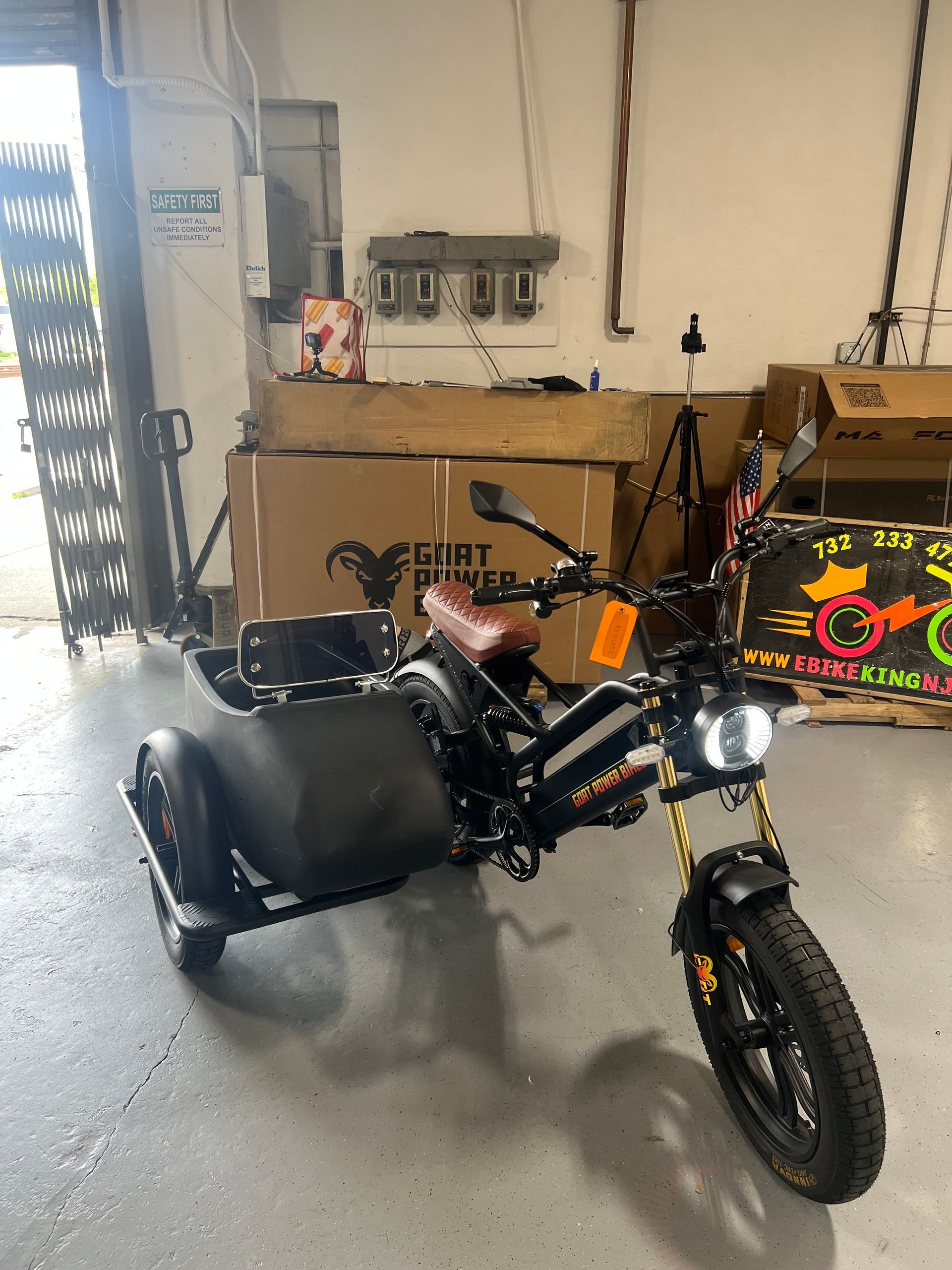 A motorcycle with a sidecar is parked in a garage.