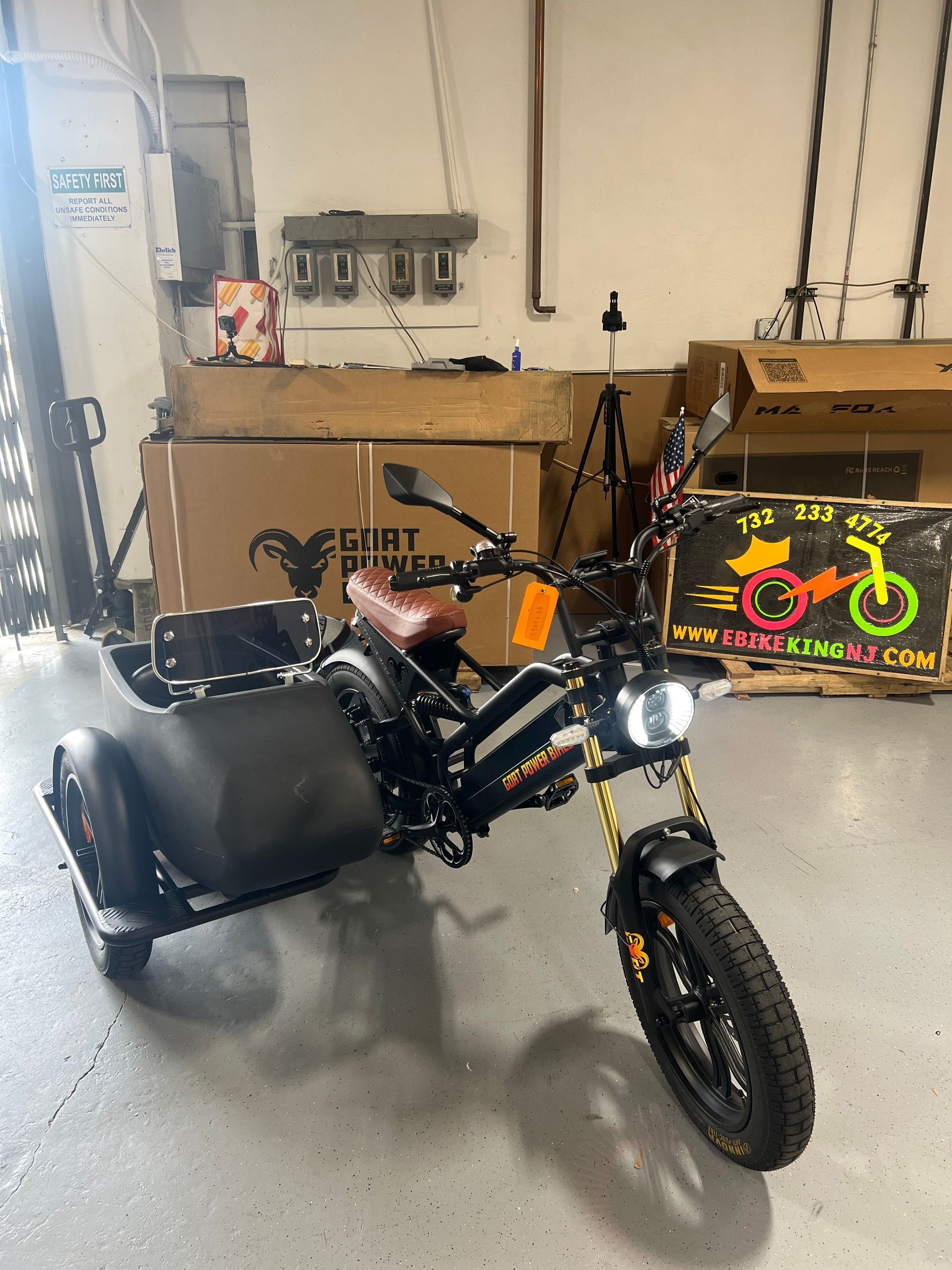 A motorcycle with a sidecar is parked in a garage.