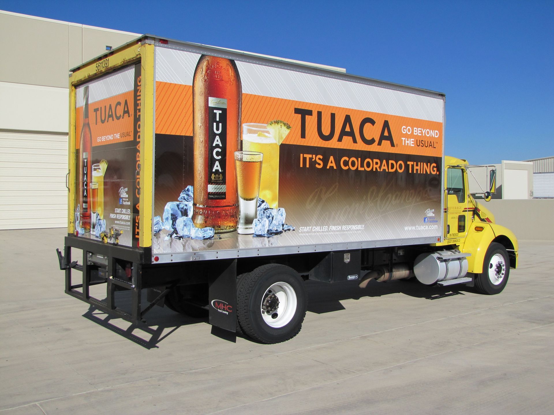 Tuaca alcohol yellow box truck full wrap Golden Colorado