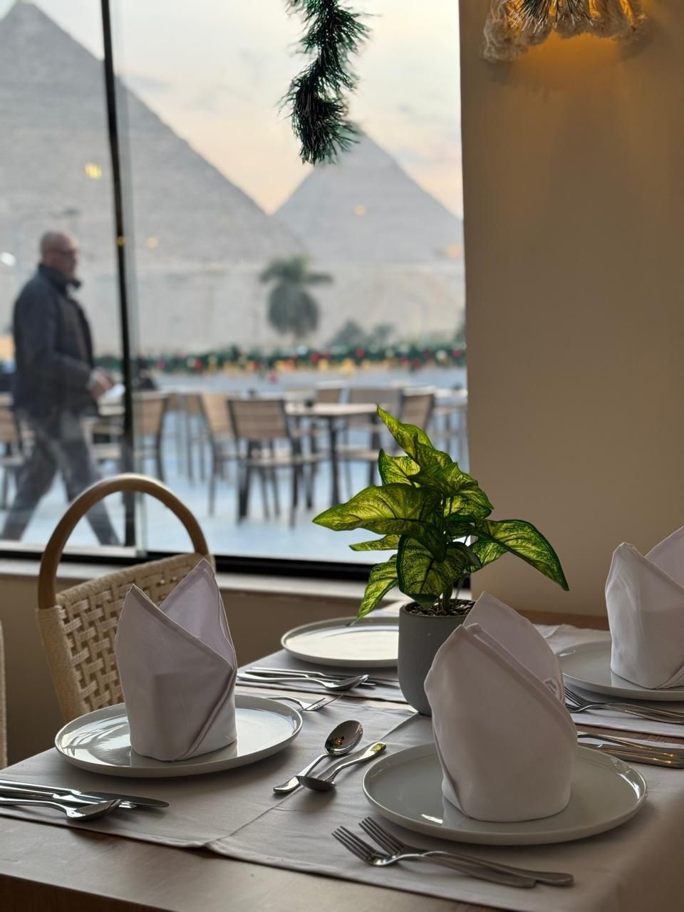 The pyramids are visible through the window of a restaurant