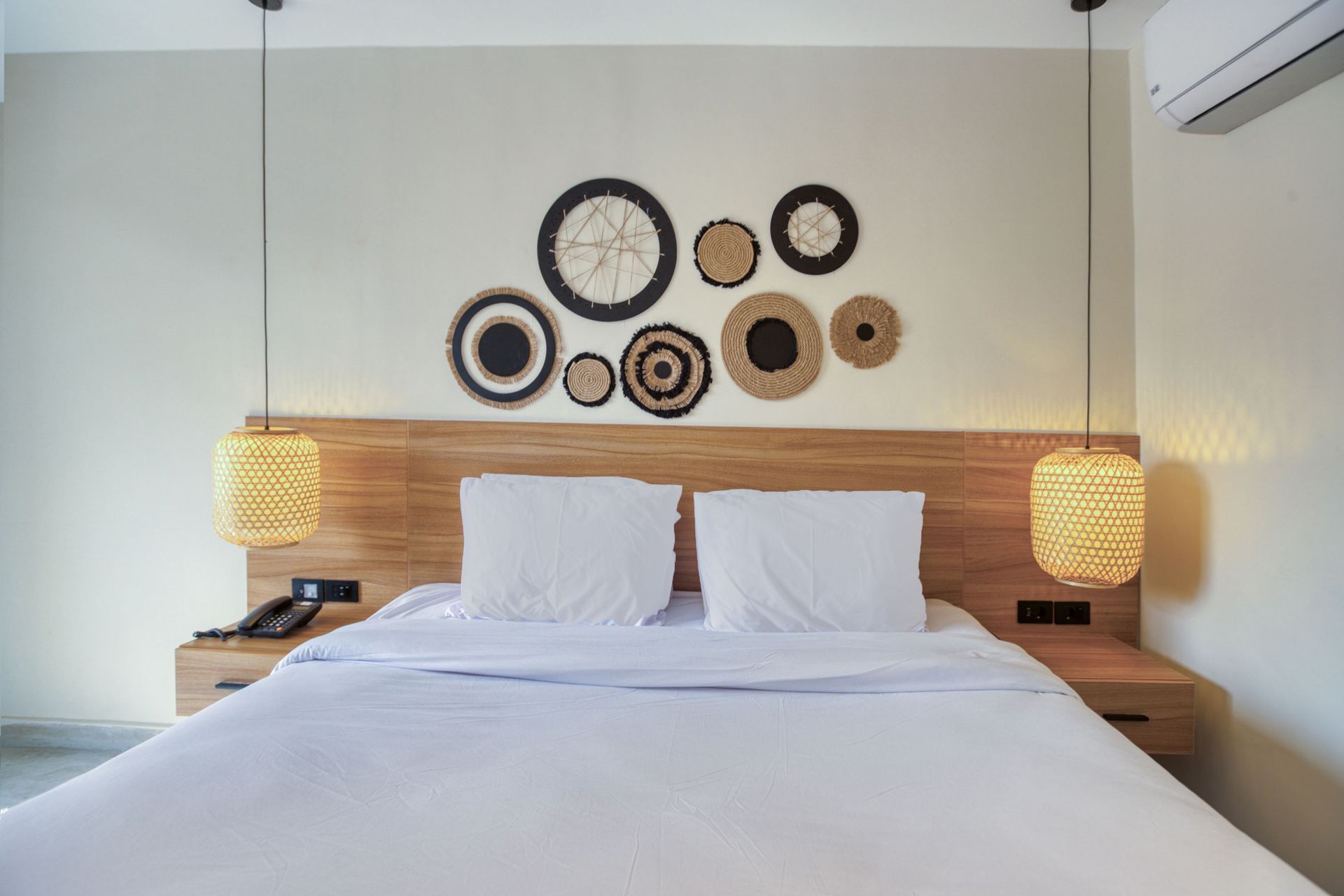 A hotel room with a pyramid in the background and a large bed.