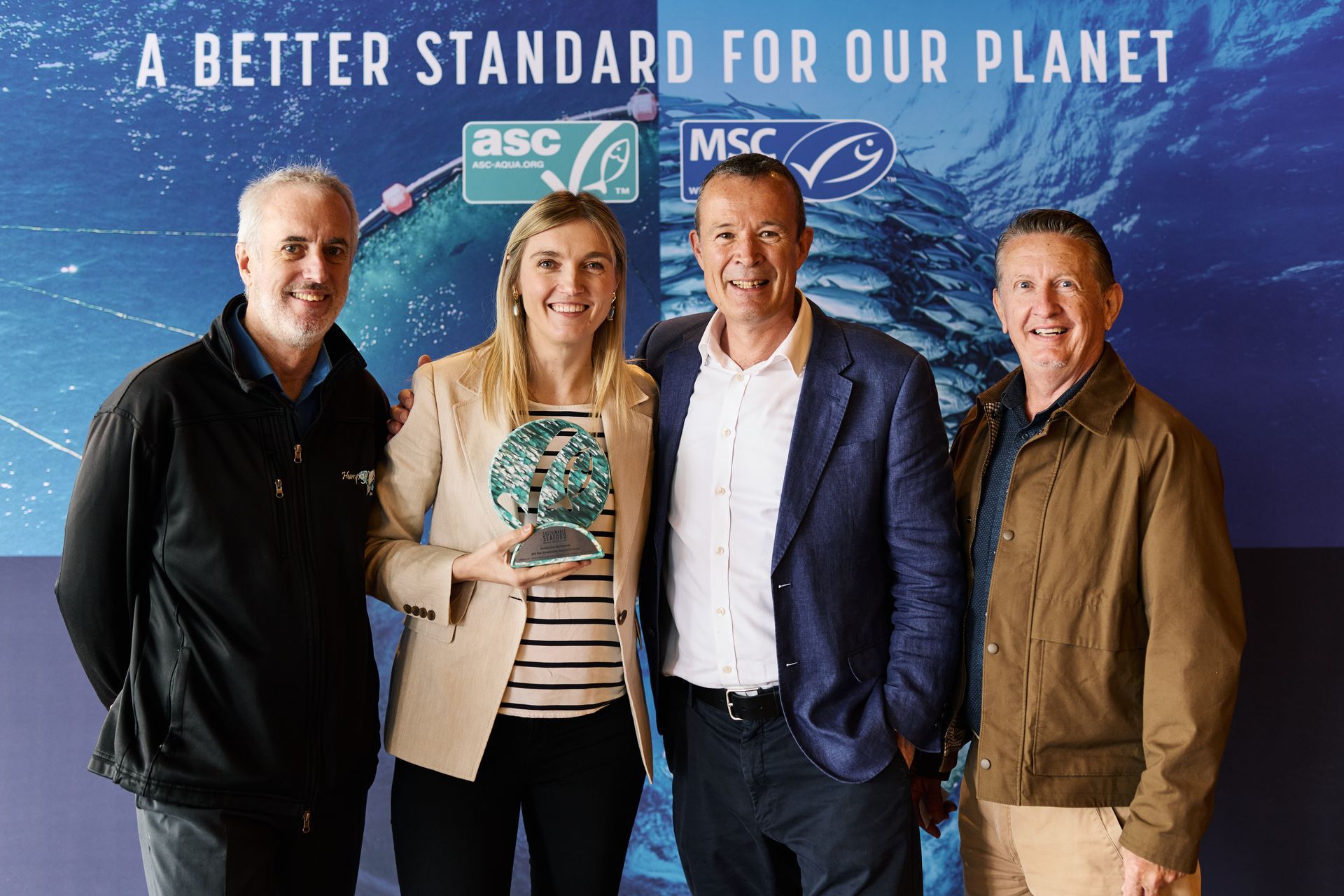 Four people stand before a