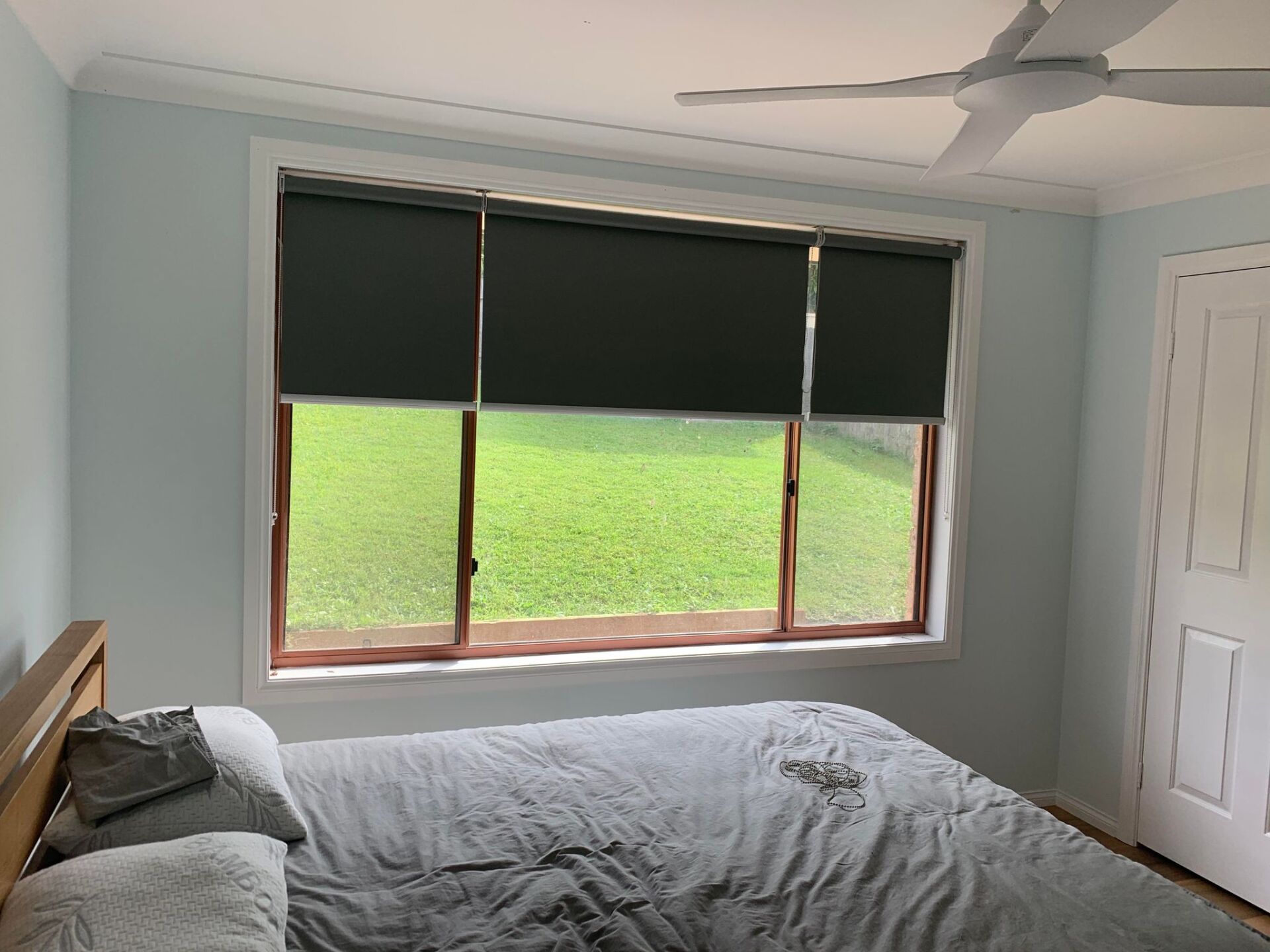 Charcoal Roller Blinds in Bedroom — Blinds, Awnings & Shutters in Mid North Coast, NSW