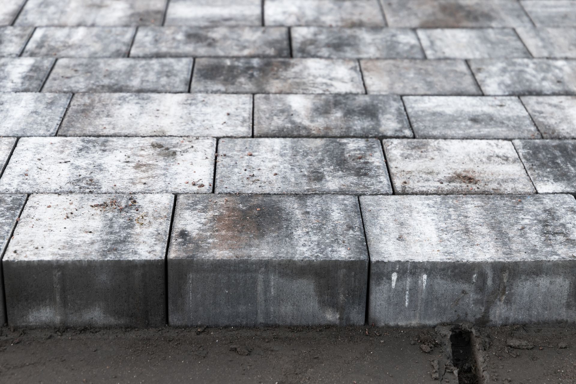 New grey paving slabs close-up; street paving is in progress
