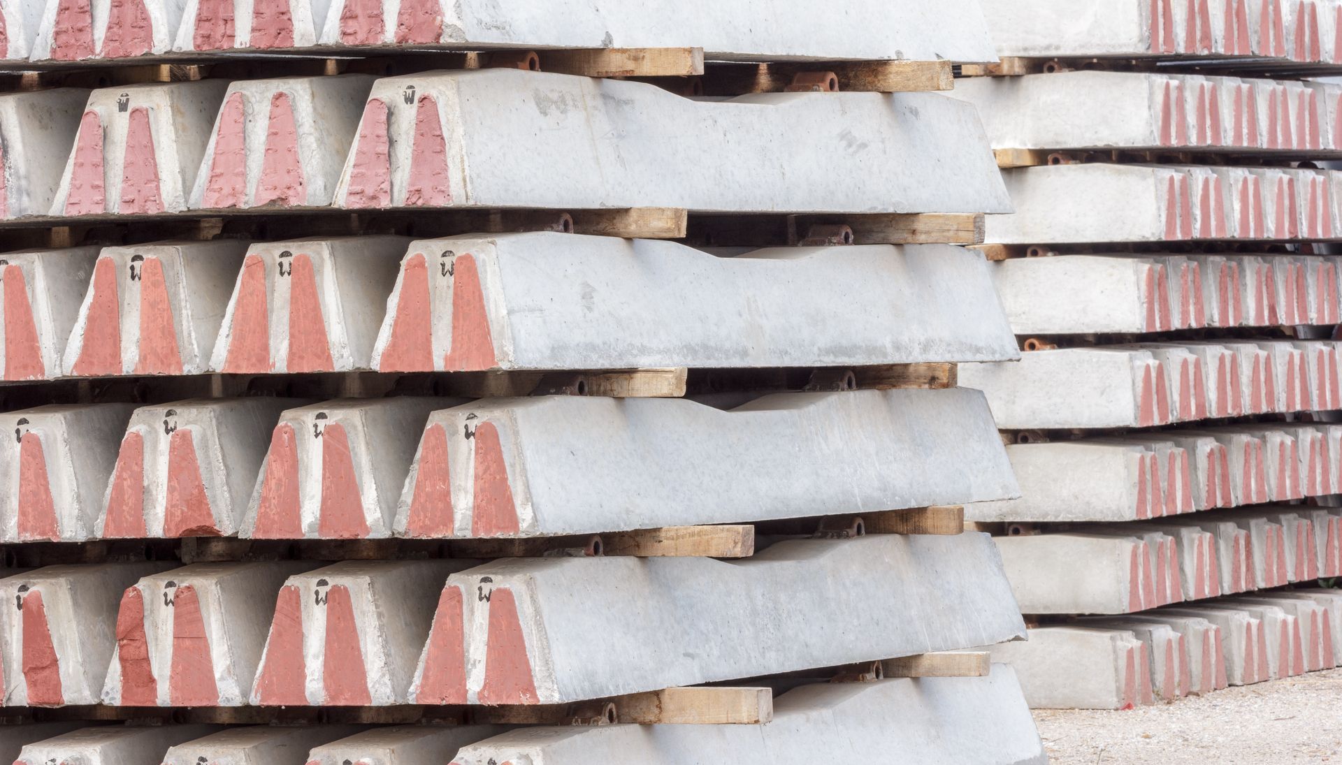 Pile of concrete sleepers outdoors.