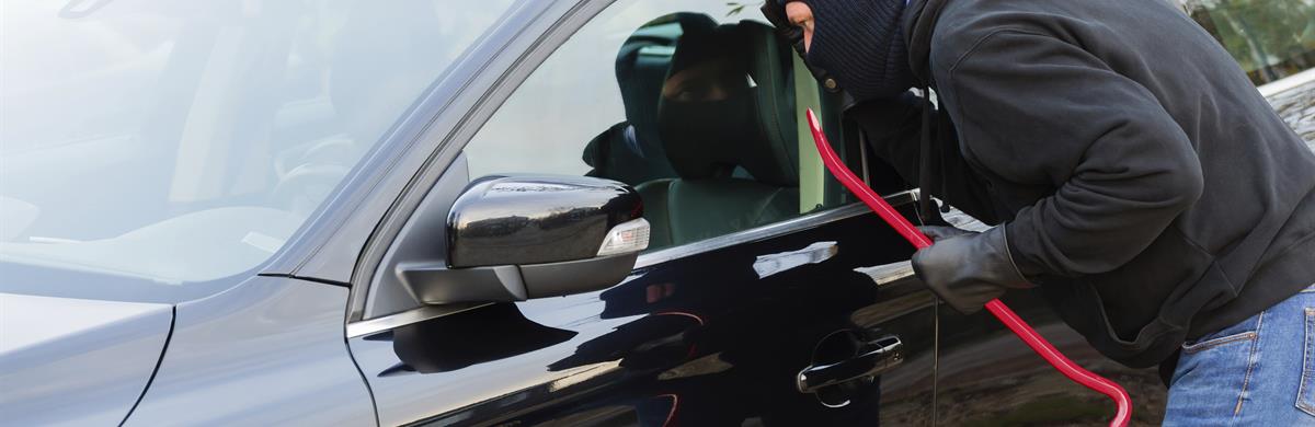 Thief breaking into car