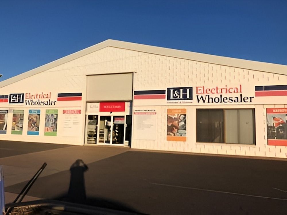 A White Building That Says Electrical Wholesaler On It — L & S Wirth Painting in Dubbo, NSW