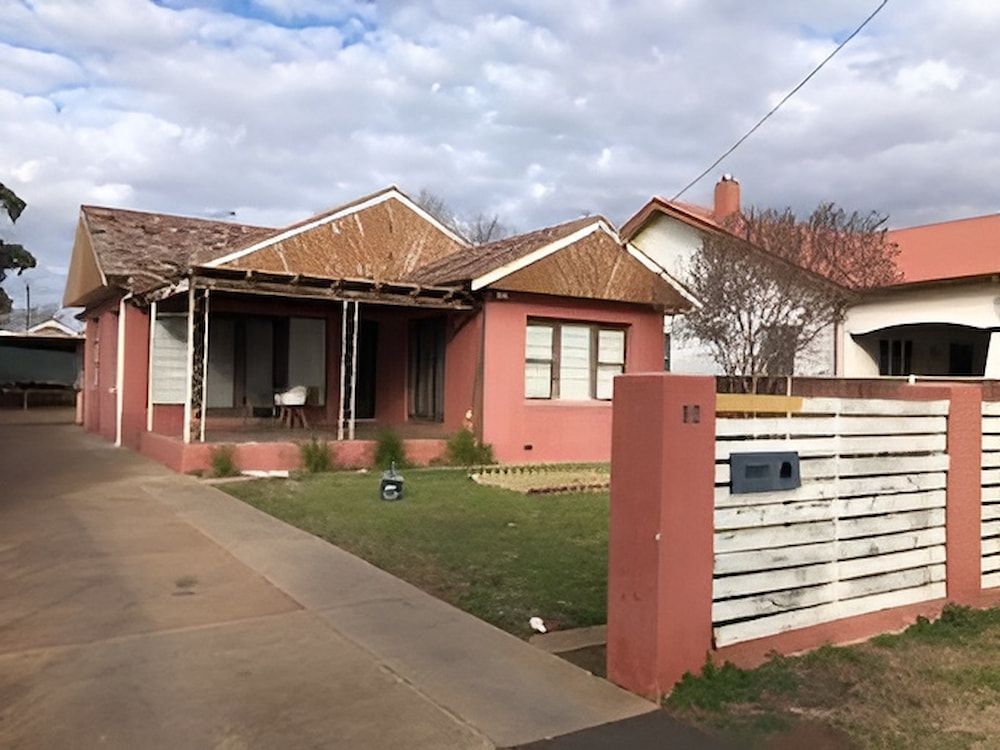 A Red House With A White Fence In Front Of It — L & S Wirth Painting in Dubbo, NSW