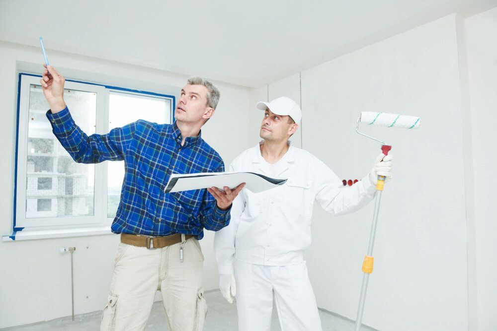 Two Men Are Standing In A Room Looking Up At The Ceiling — L & S Wirth Painting in Bourke, NSW