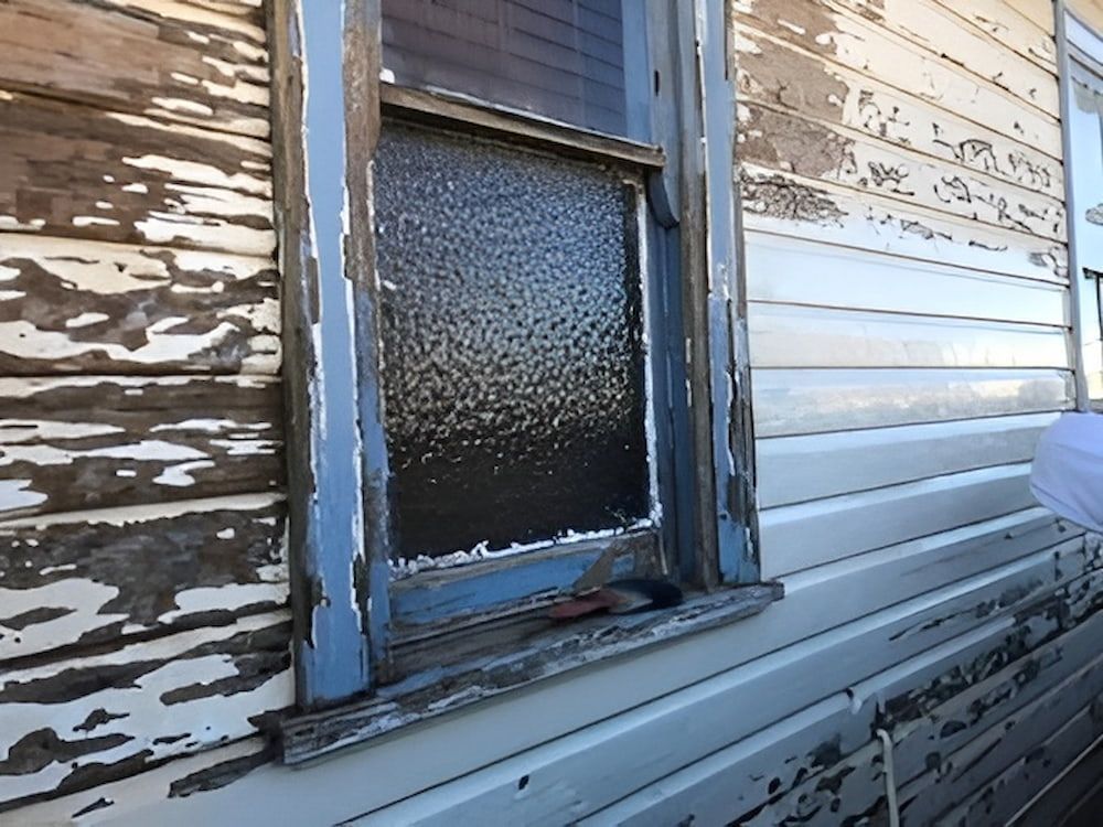 A Window On The Side Of A House With Peeling Paint — L & S Wirth Painting in Dubbo, NSW