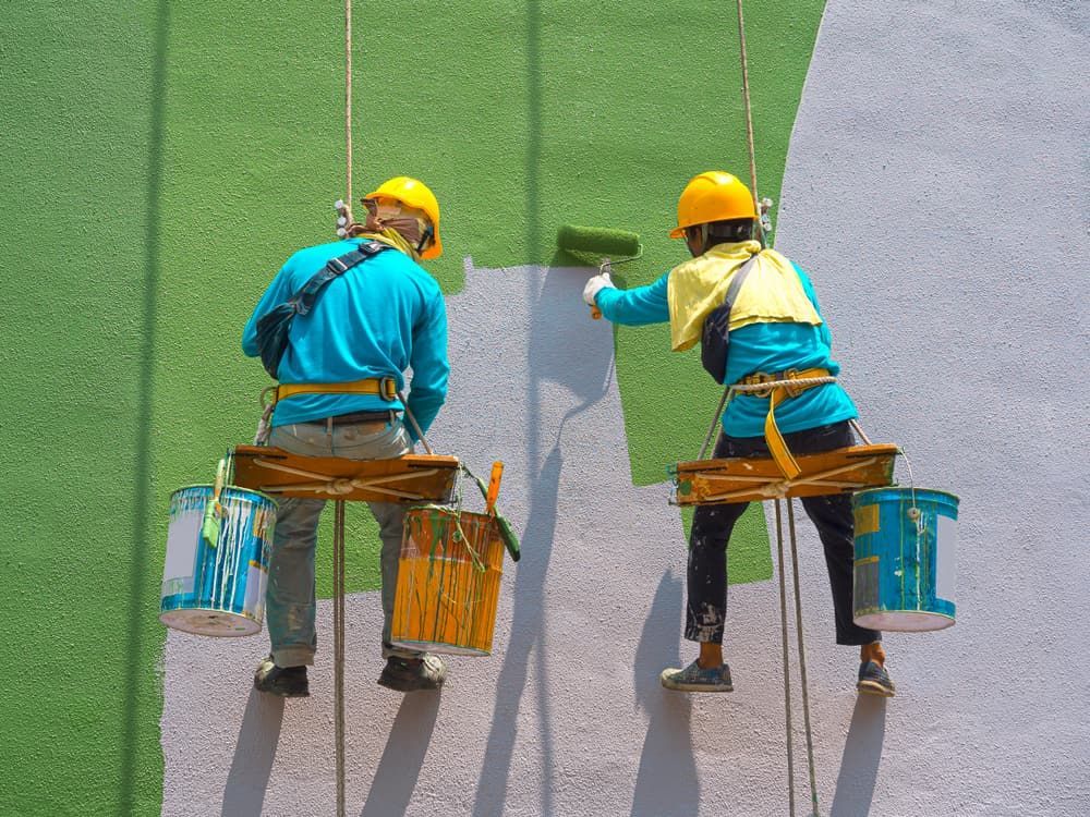 A Man And A Woman Are Painting A Wall With Rollers — L & S Wirth Painting in Nyngan, NSW