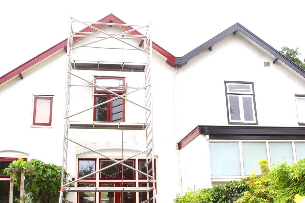 A White House With A Red Roof And A Scaffolding In Front Of It — L & S Wirth Painting in Wellington, NSW