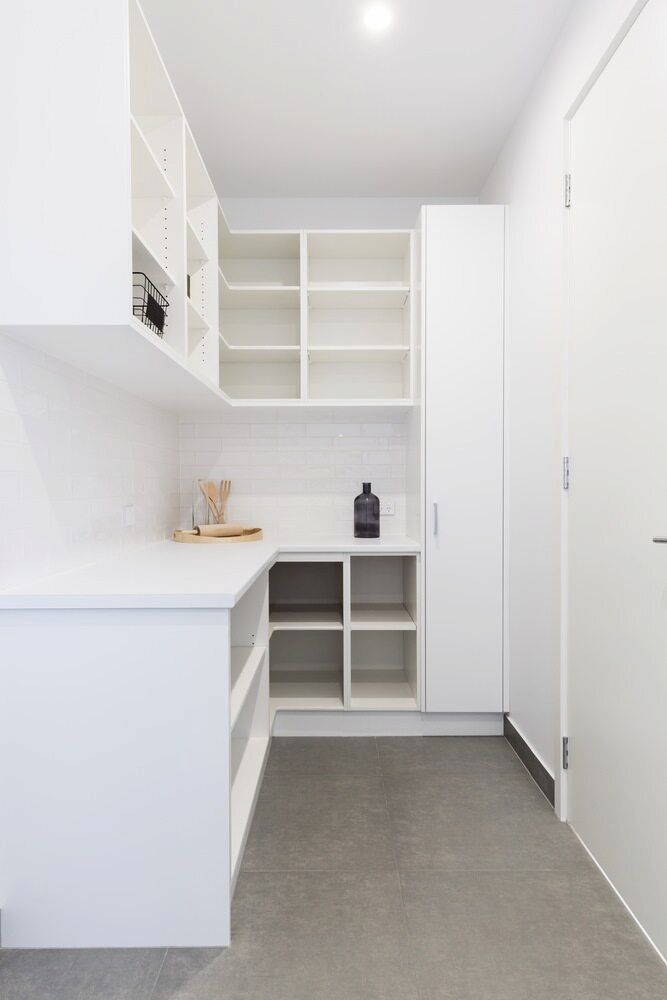 A Kitchen With White Cabinets And Shelves And A Vase On The Counter — L & S Wirth Painting in Cobar, NSW