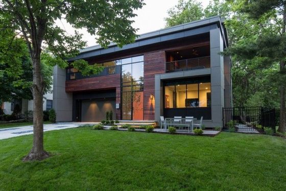 A modern house with a large lawn in front of it