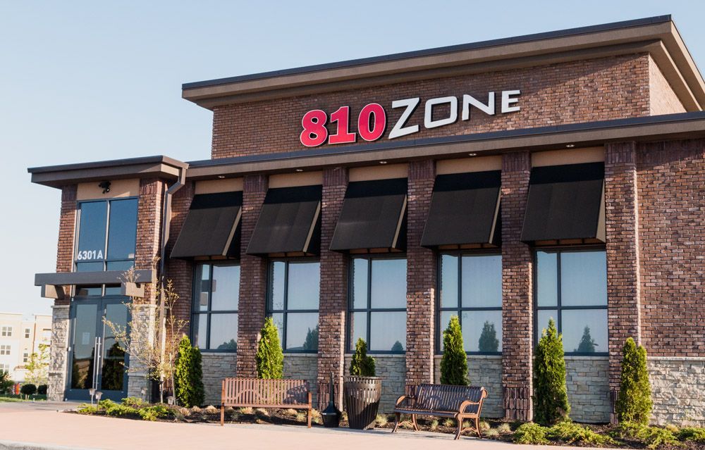 A brick building with a red sign that says 810 zone