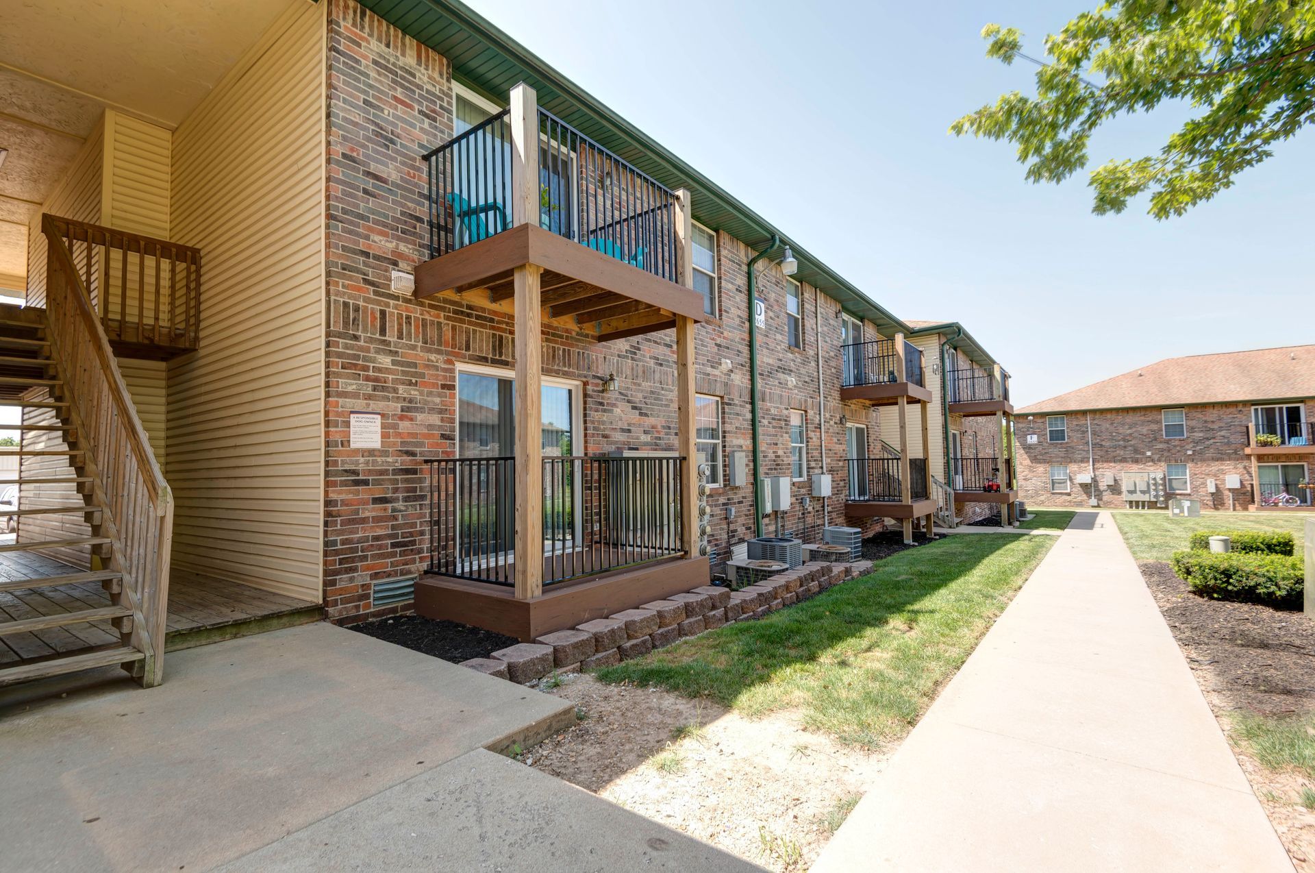 Photo of the building exterior showing steps leading up to the second story entrances