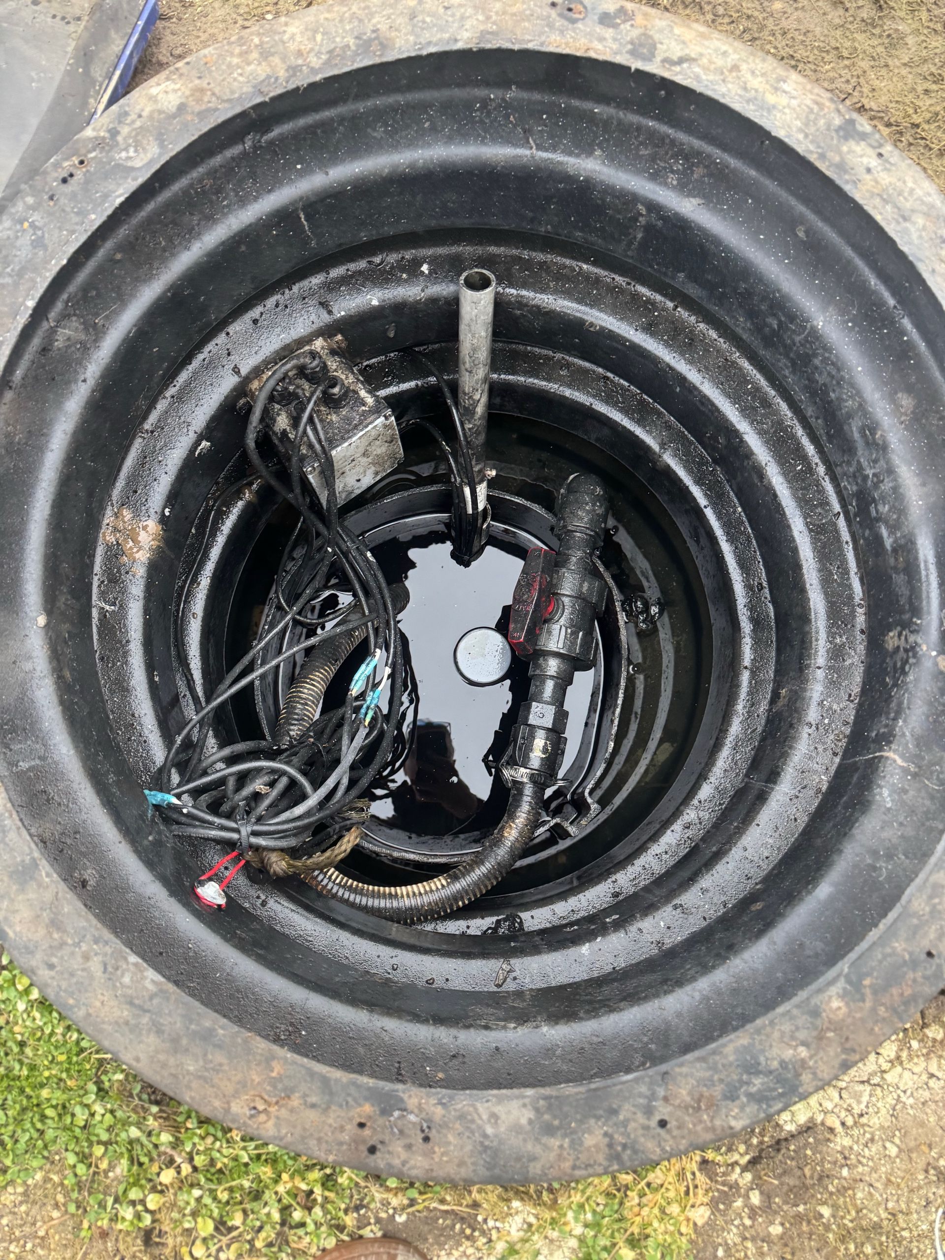 Close-up of a tire with exposed wires and damaged inner lining, showing a cut or puncture.