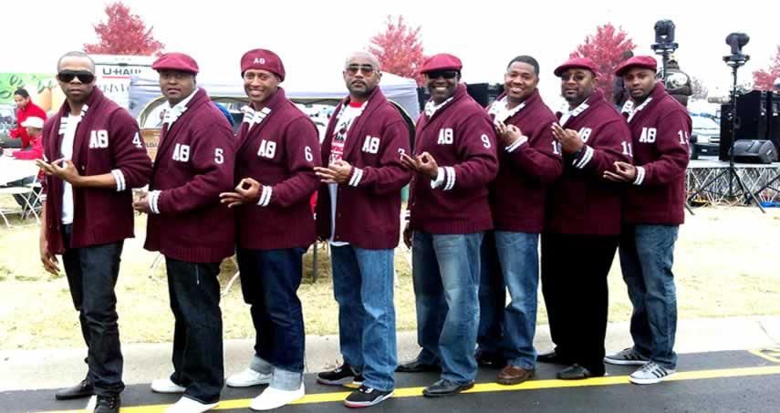 A group of men wearing maroon jackets with the letters ab on them