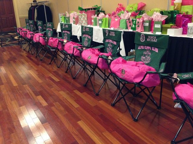 A row of folding chairs are lined up in a room